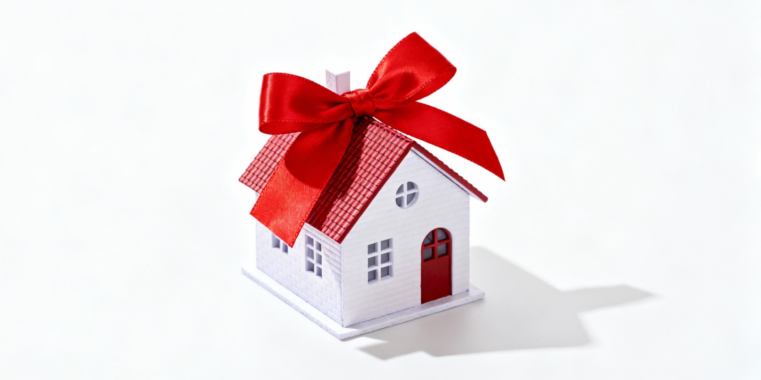 Real estate agent discussing home buying agreement with clients, showcasing a miniature building model and contract, emphasizing property investment in Boston.